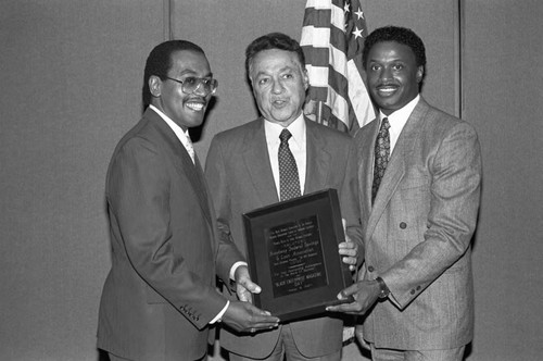 Black Enterprise Magazine luncheon participants presenting an award, Los Angeles, 1987