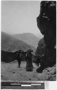 Man and woman walking on a mountain road, Mexico, ca. 1946