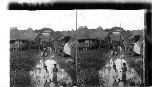 Flood tide in the outskirts of Manila among shacks built on piles. P.I