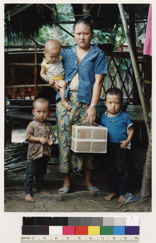 Hmong mother and sons holding parcel from relatives in Fresno, California