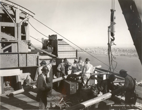 Welders, carpenters and riggers preparing the top of the tower for cable-spinning during the construction of the Golden Gate Bridge, September, 1935 [photograph]