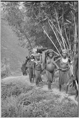 Bride price ritual: women, including bride (center) approach