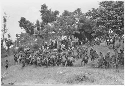 Church service in Kwiop: men and women dance on their way to Anglican church service