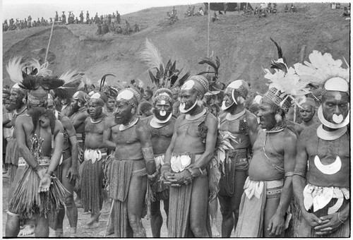 Government-sponsored festival in Tabibuga: luluais and other men await distribution of food by patrol officer