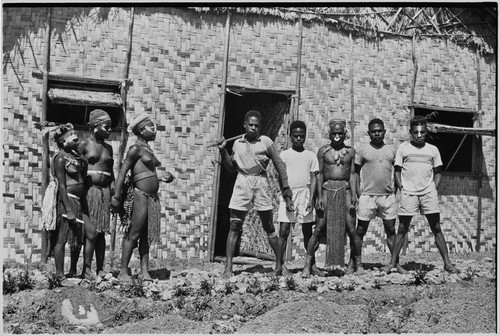 Courtship: decorated adolescent girls and potential male suitors in front of the Cooks' house