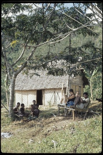 Susan Pflanz-Cook and others sitting on bench near Cooks' house