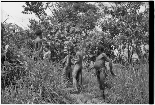 Mortuary ritual: mourners, some with clay smeared on bodies and faces as sign of mourning