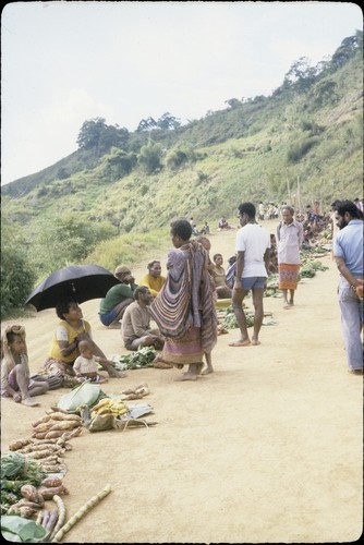 Tabibuga: people selling sweet potatoes, greens and other garden produce at market