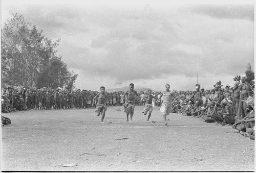 Government-sponsored festival in Tabibuga: running girls race, watched by crowd