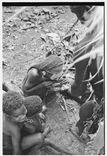 Bride price for Mitsi: woman from the bride's group is fed pork provided by groom's group