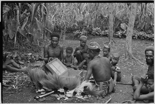 Bride price for Maima: Raggiana bird-of-paradise feathers, shell valuables and other items are unpacked from a chest