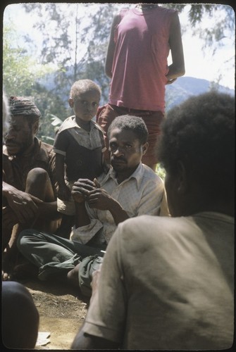 Ndemang Kuk and others gambling on a card game