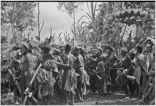 Bride price ritual: decorated men and boys dance in front of payment banner