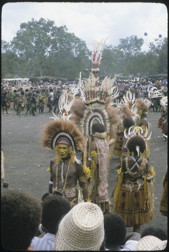 Port Moresby show: elaborately costumed dancers with feathered headdresses, necklaces strung with teeth, brightly dyed skits, barkcloth cape
