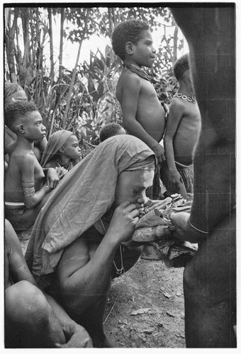 Bride price for Mitsi: woman from the bride's group is fed pork provided by the groom's group