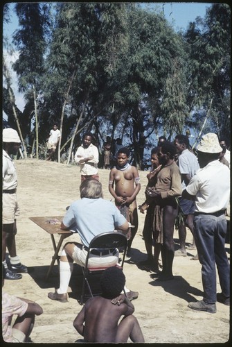 Government patrol officer taking census and collecting taxes from local people