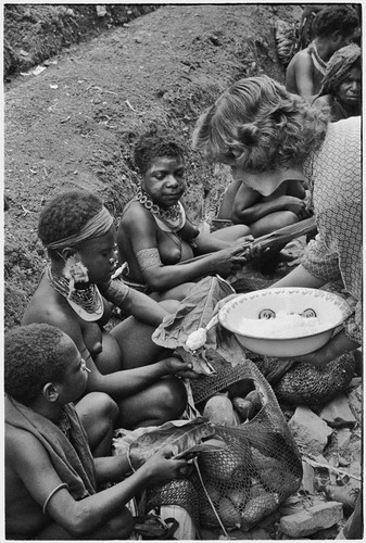 Nancy Cook giving salt to Kwiop women, who have brought sweet potatoes to exchange