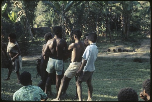 Local court case, child being pulled by men during a dispute over child's place between two groups