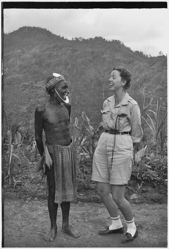 Anthropologist Denise O'Brien laughs with man wearing large kina shell jewelry