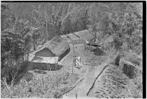 Edwin Cook's house in Kwiop: wife Nancy Cook hangs laundry