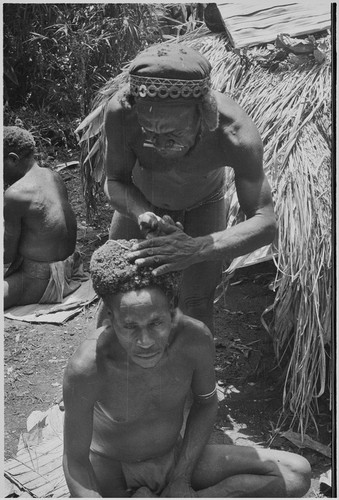 Pig festival, wig ritual: hair is fastened to wig frame