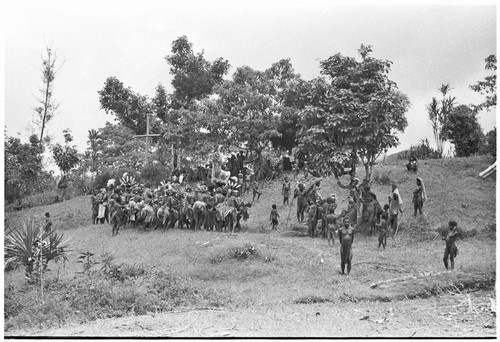 Church service in Kwiop: men and women dance on their way to Anglican church service