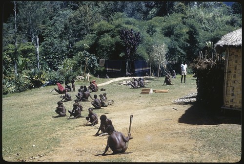 Kwiop, women cutt grass near government rest house