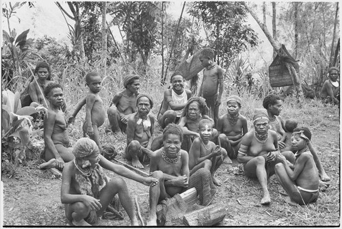 Returned laborers, purification ritual: women and children have gathered to watch