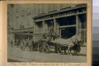 The Water Tower in front of the San Francisco Fire Dept. Corporation Yard. North Side of Sacramento St. About 1889. Capt. Frank Crockett standing at the front wheel