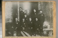 At the Vault Door of the Treasury of the City and County of San Francisco, Calif., after the fire of April 18/06. See the paper seal on the door. Those in the photo are L to R. Sergt. Ross - City and County Treasurer Bartell - Police Officers Maloney - P. Burns - S. Sandman - R. Ingham - H. Barnett - C. Jenkins and Chief Deputy Treasurer