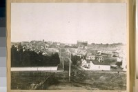 North on Fillmore St. from Green St. in 1886. The corner with the white fence is the old Frank Pixley's house. N.W. cor. Green & Fillmore St. The buildings on the right of the gas tank is [sic] Fort Mason