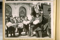Two photos of Mr. J.S. Dunnigan, Clerk to the Board of Supervisors, receiving the S.F. [San Francisco] Police Petition for an increase of salary at the New City Hall to be voted on at the Nov. election, 1920