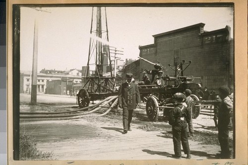 Chief D. Sullivan, S.F. [San Francisco] Fire Dept. testing water tower on Bay St., 1914