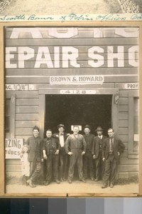 [Group standing outside building, "Brown & Howard"]