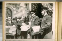 Two photos of Mr. J.S. Dunnigan, Clerk to the Board of Supervisors, receiving the S.F. [San Francisco] Police Petition for an increase of salary at the New City Hall to be voted on at the Nov. election, 1920
