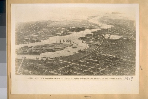 Aeroplane view looking down Oakland harbor. Government Island in the foreground. 1919