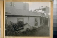 Side view of the house at 1256 ½ Howard St. showing the window that the Stanley girl jumped through (the one covered by boards), Dec. 1920