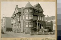 The home of Mrs. M.T. Emerson, the widow of the late Minstrel Wm. or Billie Emerson. Mrs. Emerson is on the steps with Jesse B. Cook. (N.W. cor. Baker & Grove Sts.)