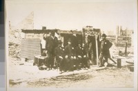 Photo taken in April 1906 after the fire of April 18/06. N.E. cor. McAllister & Hyde Sts. The Harbor Police guarding the City & County Treasurer's Office in the City Hall. L. to R.--Major Hugh Syme Dep. Treasurer, Michael Barry--police officer, Thos. Flinn--police officer, special officer not known, Peter O'Keefe Sergt. of Police