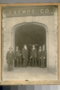 Exempt Fire men standing in front of old Exempt Fire house on Brenham Place bet. Clay and Washington - Kearny and Dupont Sts. 1890. Left to Right: 1. 2. Jas. Kentzel 3. Kline 4. J.L. Dirker