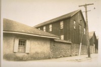 Old adobe wall with a shed over it opposite the casa on Polk St. Built about 1826 at Monterey Calif. Jany. 1929. This is a part of the Old Molera property and in front of this building & sheds was the old bull ring & pens on Munras Ave., formerly California Street. Built by Captain John B.R. Cooper