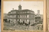Lincoln School East side of 5th St. bet. Market & Mission Sts. in 1870. The dark building in back is the old State Normal School and the one with the clock was St. Ignatius College. The stones on the sidwalk [sic] are for the U.S. Mint