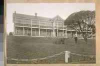 Company Headquarters on the road to Fort Winfield Scott. Built about 1860. Jesse B. Cook on the bank in front