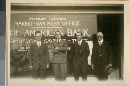 The Branch of the American Bank on Market St., west of Van Ness Ave. North Side. Nov. 1/26. L. to R.: Manager E.C. McMellen - Ass. Mgr. N.B. Turner, and J.B. Cook - in the center is W.B. Wehlden - Teller