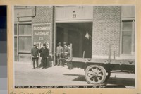 North side of Townsend St. bet. 7th & 8th St. Jack McGilvray standing with his thumbs in his vest pockets. 1920