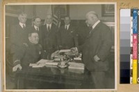 Auto Dealers Ass. hand Chief O'Brien $1000.00 for the Police Chiefs Meet here in June 1922. L. to R. Jesse B. Cook Police Com. E. Epstein. Capt. of Detectives D. Matheson. A.F. Lemberger Gen. Manager and W.S. Culberson, Pres. with Chief of Police D.J. O'Brien seated