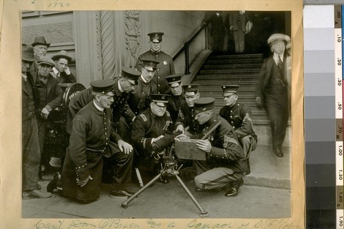 Capt. Dan O'Brien and a squad of S.F. [San Francisco] Police Officers receiving instructions in the handling of a machine gun by the U.S. Marin's [Marines] in front of the Hall of Justice. Sept. 18th, 1920