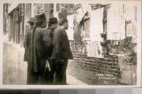 The Dead Walls of China Town at the N.W. cor. Washington & Dupont St. in 1900 - see the ques [sic] on the men. China Town - San Francisco