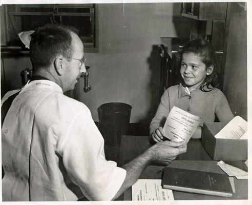 [Beatrice Pachecco getting an "okay" certificate from Mission Health Center]