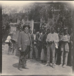 Missionary Roland Leenhardt with his pupils who are singing a farewell song